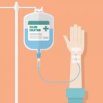 Saline Solution Bag With Patient Hand Stock Photo