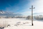 Austrian Winter Wonderland With Mountains, Fresh Snow And Haze In The Sunlight Stock Photo