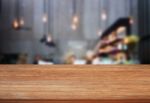 Top Wooden Table With Blurred Cafe Background Stock Photo