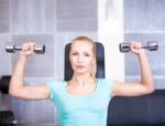 Attractive Blond  Sporty Girl Doing Shoulders Training Wi Stock Photo