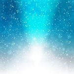 Falling Snow On The Blue Background With Light Stock Photo