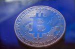 Blue Light On Bitcoin Currency Coin Extreme Close-up Stock Photo