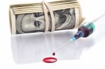 Blood Drops From Syringe Needle With 100 Dollars Banknotes In Background Stock Photo