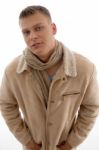 Young Male Wearing Coat And Looking At Camera Stock Photo