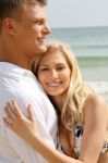 Smiling Young Couple At Beach Stock Photo