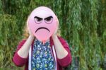 Girl Holding Balloon With Angry Face Stock Photo