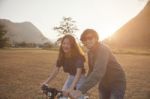 Couples Of Younger Asian Man And Woman Practice To Riding Bicycle In Natural Field Relaxing Emotion Stock Photo