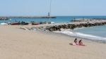People Sunbathing On The Beach At Puerto Banus Stock Photo