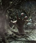 Hand Of Monster Rising From The Ground In Haunted Forest Stock Photo