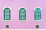 Three Green Arched Windows On Pink Wall Stock Photo