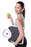 Fir Woman With Weighing Scale And Green Apple Stock Photo