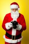 Santa Checking Pictures On His Dslr Camera Stock Photo