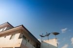Home And Satlelite On A Roof With Blue Sky Stock Photo