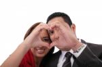 Happy Couple In Love Showing Heart With Their Fingers Stock Photo