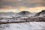 Snowy Icelandic Mountains With Dramatic Cloudy Sky Stock Photo