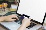 Women Hands Hold Credit Or Debit Card (atm) And Notebook Or Laptop On Work Table Stock Photo