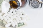 White Pills And Money On White Background Stock Photo