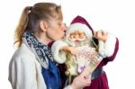 Woman Kissing Model Of Santa Claus Stock Photo