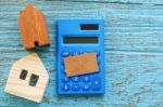 Wood House And Calculator With Blank Card Stock Photo