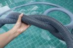 Girl Hand Holding Twisted Swimming Pool Vacuume Hose Stock Photo