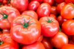 Close Up Of Fresh, Juicy, Ripe Tomatoes Pile. Lycopene And Antioxidant In Fruit Nutrition Good For Health And Skin. Flat Lay Stock Photo