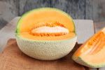 Melon Cut On Wooden Stock Photo