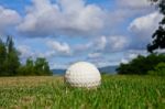 Golfball On Course And Blue Sky Stock Photo