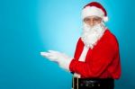 Santa Against Blue Background Posing With Open Palms Stock Photo