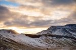 Snowy Icelandic Mountains With Dramatic Cloudy Sky Stock Photo