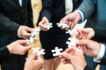 Teamwork - Business People Solving A Puzzle Stock Photo
