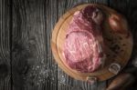 Raw Angus Beef  With Seasoning On The Wooden Table Top View Stock Photo