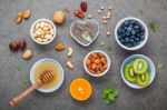 Ingredients For A Healthy Foods Background, Nuts, Honey, Berries Stock Photo
