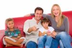Couple Watching Tv With Children Stock Photo