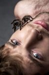 Portrait Of A Young Handsome Man With Spider On His Face Stock Photo