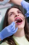 Dentist Curing A Female Patient Stock Photo