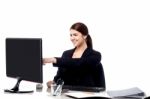 Female Staff Pointing At Monitor Screen Stock Photo