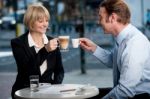 Business Partners Toasting Coffee At Cafe Stock Photo