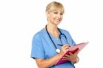 Physician With Clipboard Smiling At Camera Stock Photo