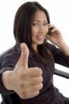 Woman Showing Thumbs Up While Talking Stock Photo