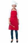 Cheerful Senior Female Chef With Spoon Stock Photo