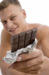 Smiling Guy Showing Chocolate Stock Photo