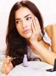 Woman In Bed Applying Nail Polish Stock Photo