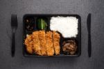 Japanese Food Tonkatsu Rice And Vegetable Take Away On Table Background Stock Photo