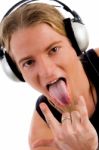 Man Listening Music With Tongue Out Stock Photo