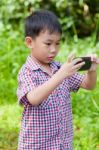 Little Boy Taking Photos By Digital Camera On Smartphone With Go Stock Photo
