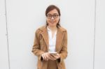 Portrait Of Thai Adult Businesswoman Beautiful Girl Using Her Smart Phone Stock Photo