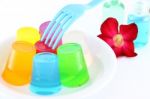 Multiple Cold Jellies On Dish And Blue Fork Stock Photo
