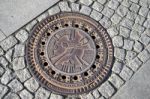 Intricate Waterboard Manhole Cover In A Street In Berlin Stock Photo