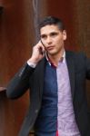 Portrait Of A Young Man With Talking On The Phone Stock Photo