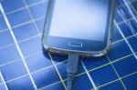 Charging Mobile Phone With Solar Charger Stock Photo